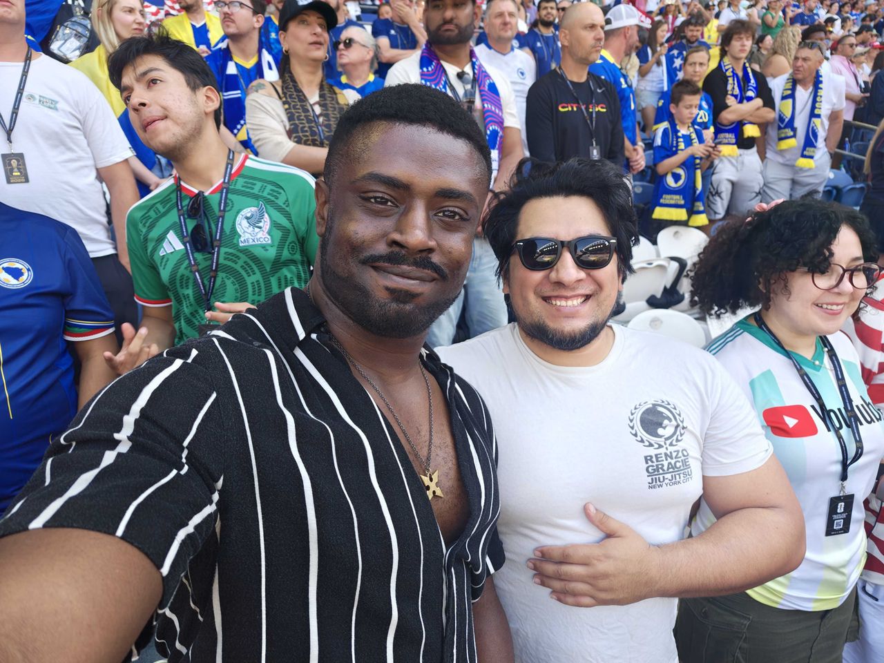 Two men smiling next to each other in the stands