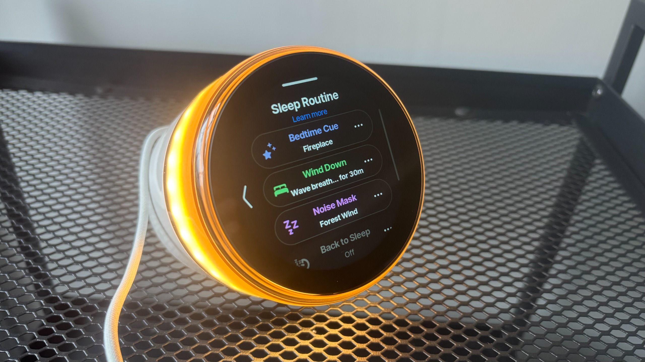 The Ambient Dreamie on a nightstand displaying the Sleep Routine feature, complete with different ambient sounds.