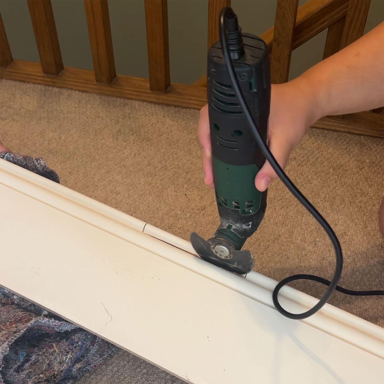 Person sanding skirting board cover