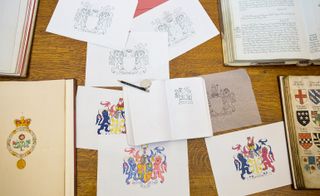 Hand-drawn sketches of the coat of arms used in the design of the Olympics strip