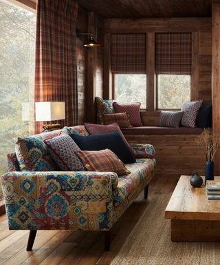 Cabin-style paneled living room with Iliv Chalet fabrics