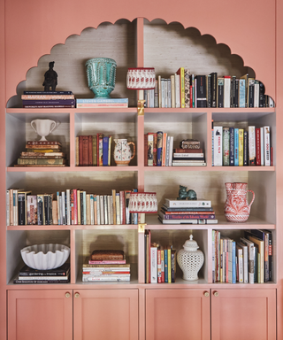 colourful pink bookshelf with scallop edge and lots of books i