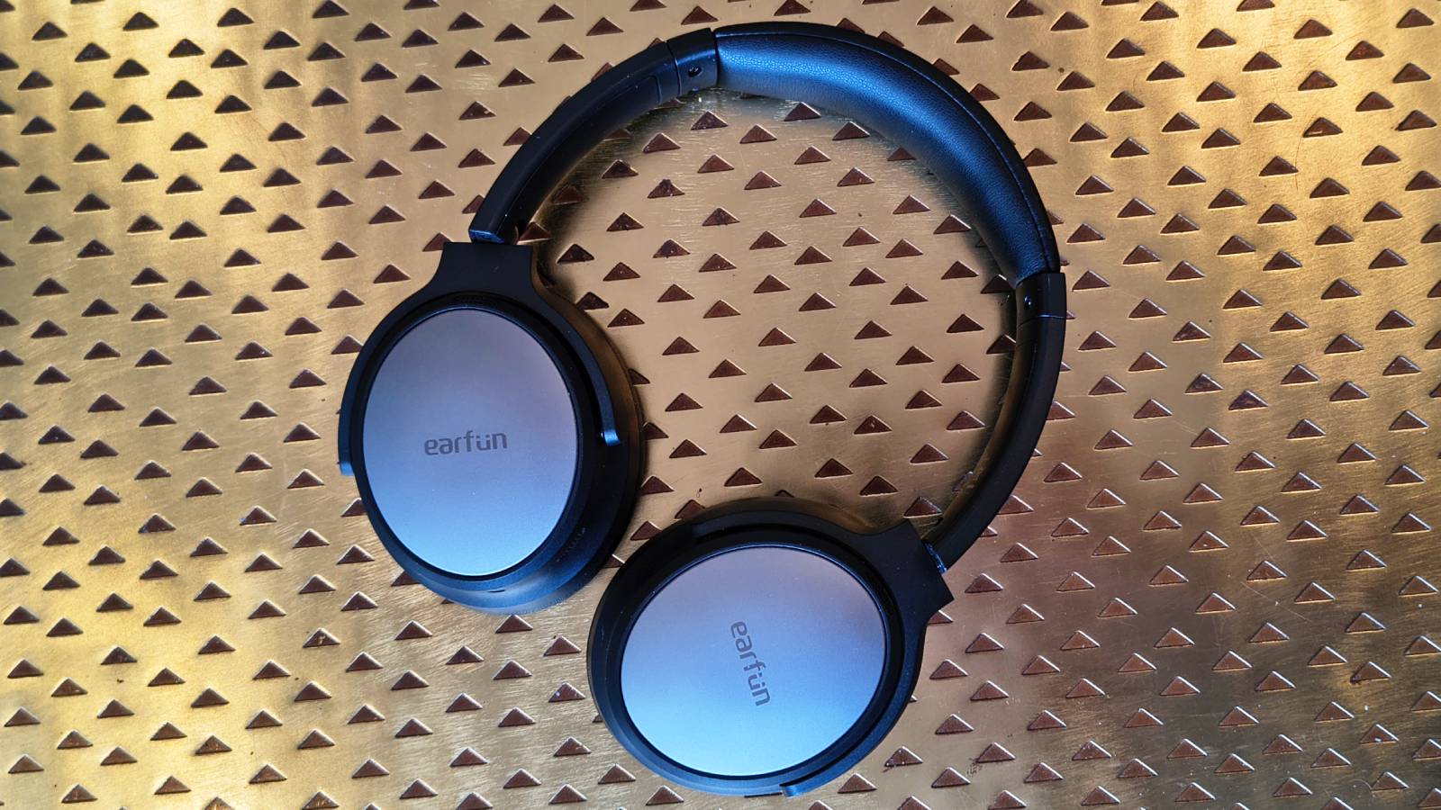 The Earfun Tune Pro atop a bronze table.