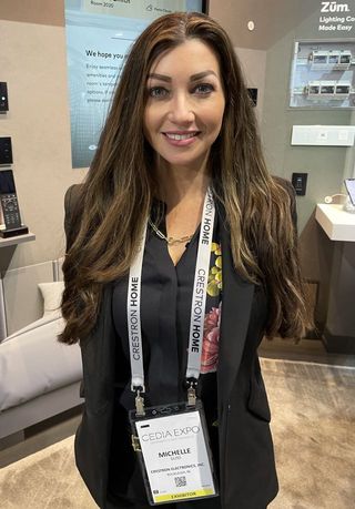 Crestron's Michelle Guss smiling at the CEDIA Expo booth.