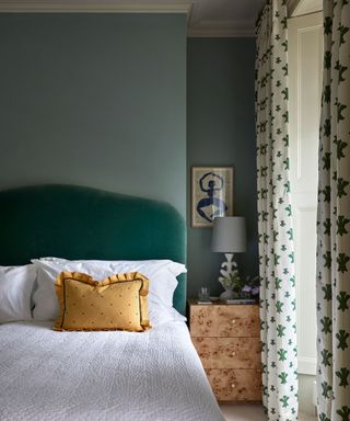 green bedroom with velvet headboard and beata hueman curtains