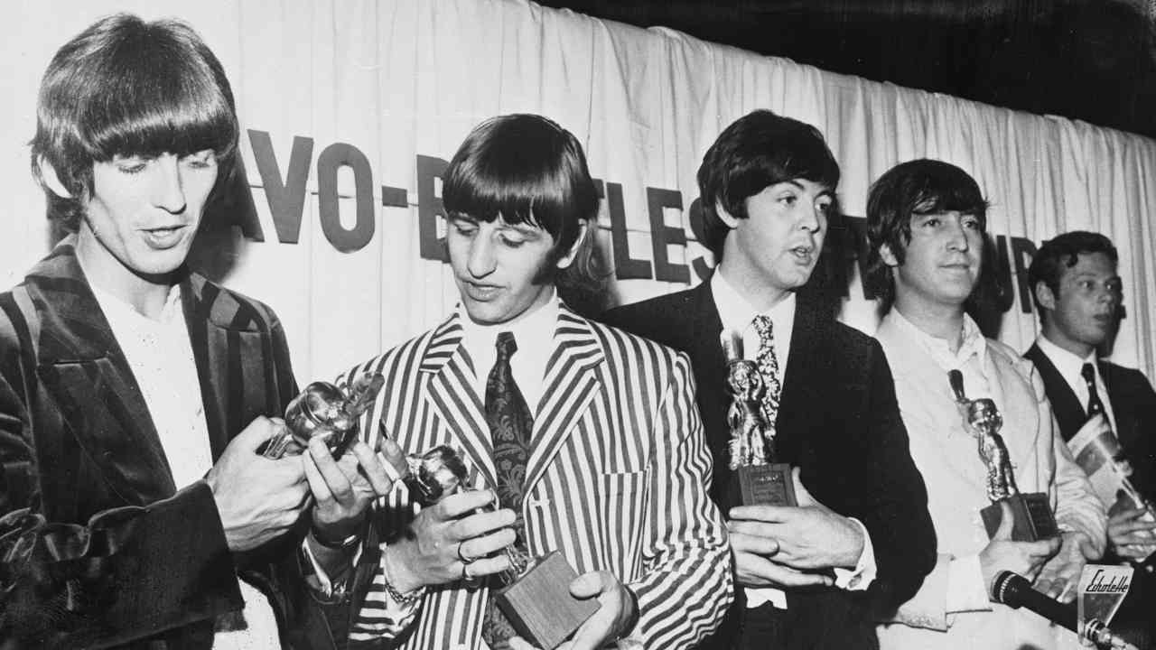 The Beatles posing for a photograph in 1966