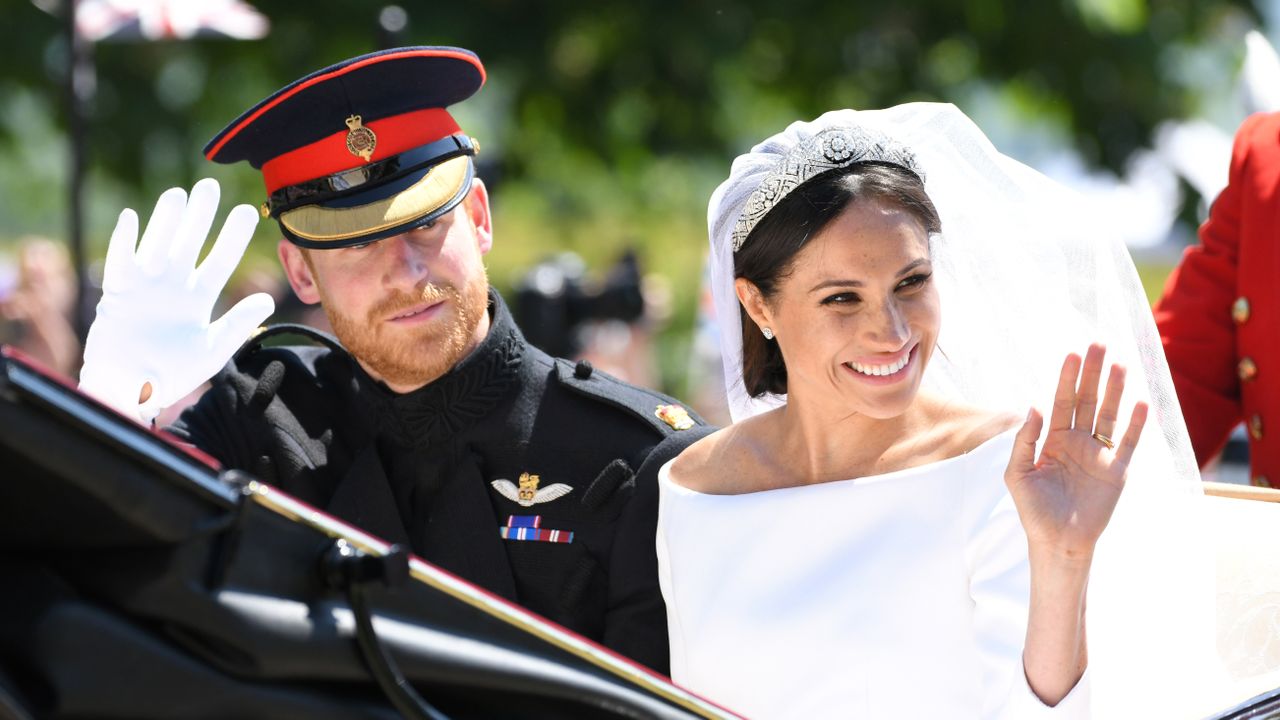 Prince Harry, Duke of Sussex and Meghan, Duchess of Sussex leave Windsor Castle in the Ascot Landau carriage during a procession after getting married at St Georges Chapel on May 19, 2018 in Windsor, England