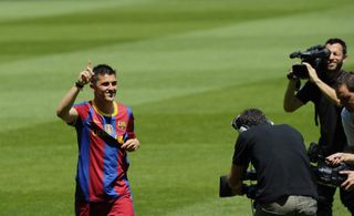 David Villa waves to the fans during his official presentation as a Barcelona player at Camp Nou in May 2010.