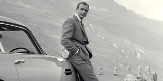 Goldfinger Sean Connery leaning against his Aston Martin