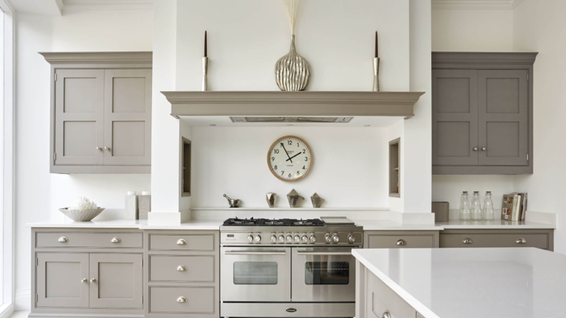 Grey Shaker kitchen with stainless steel rangemaster oven and round wall clock