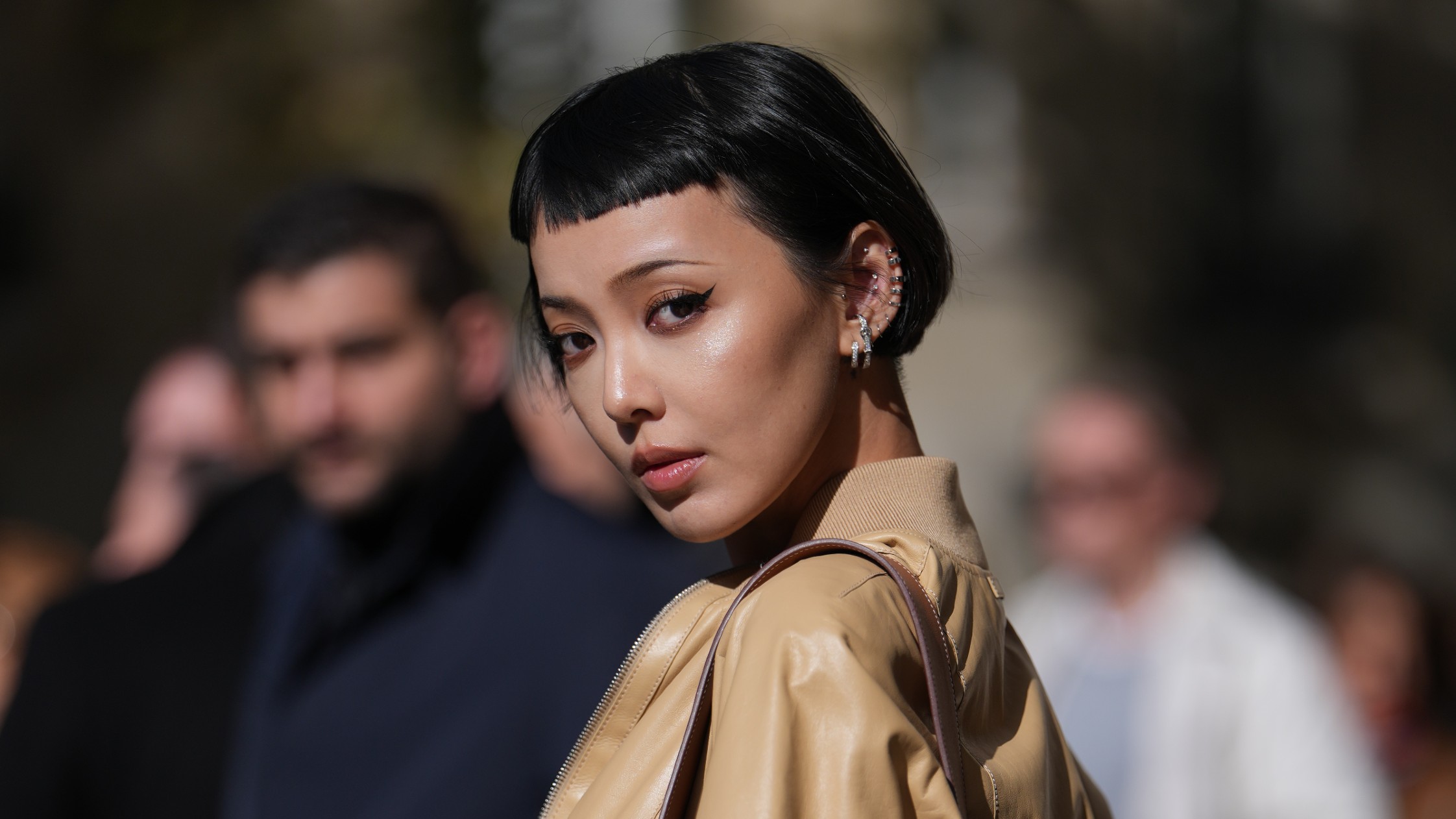 A model wearing their hair styled with micro bangs.