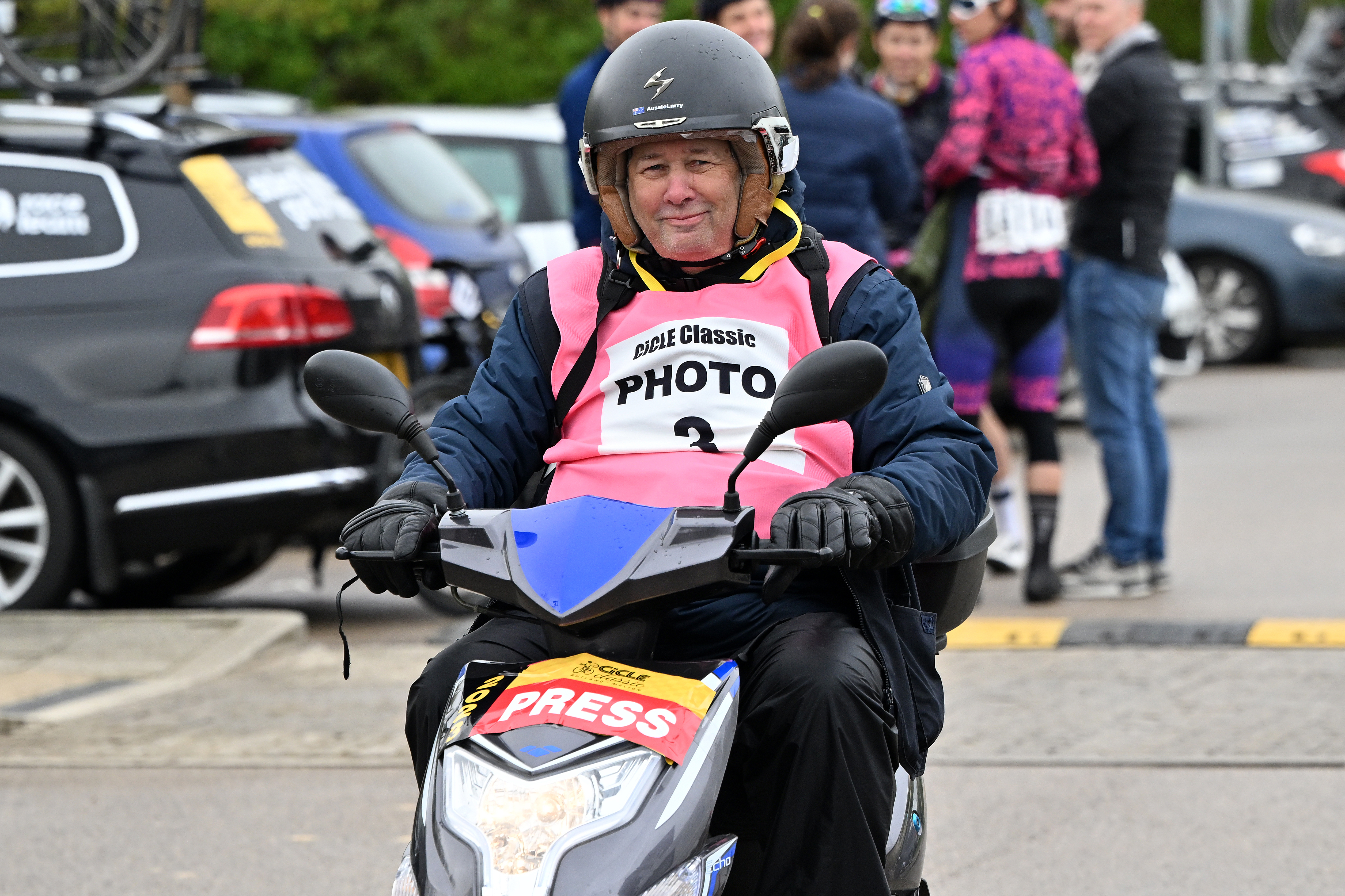 Larry Hickmott rides a moped