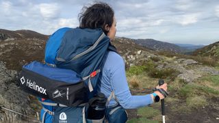 Julia Clarke backpacking with the Helinox Chair One (Re) strapped to her pack