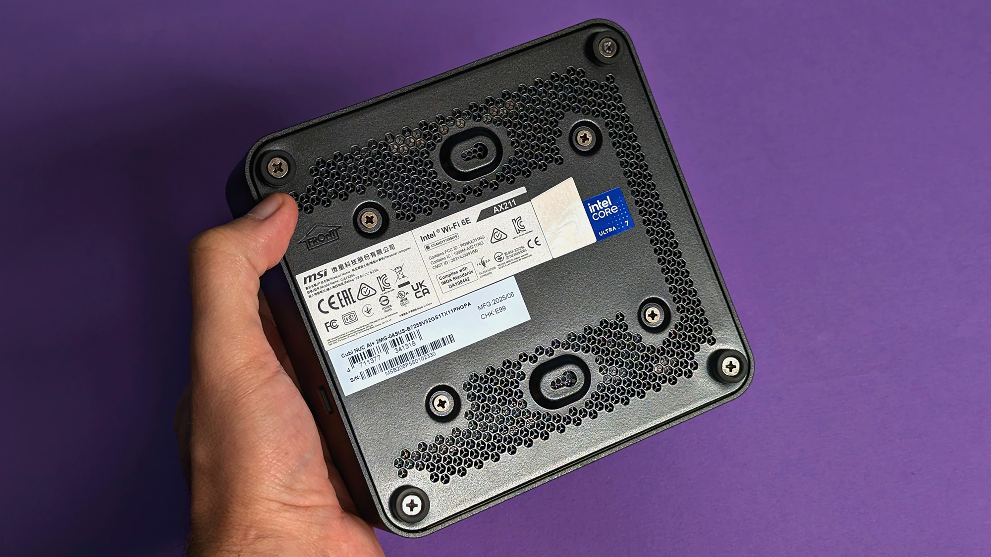 MSI Cubi NUC AI+ 2MG mini PC on a purple card stock background