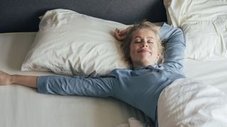 A woman stretches out on a king size mattress