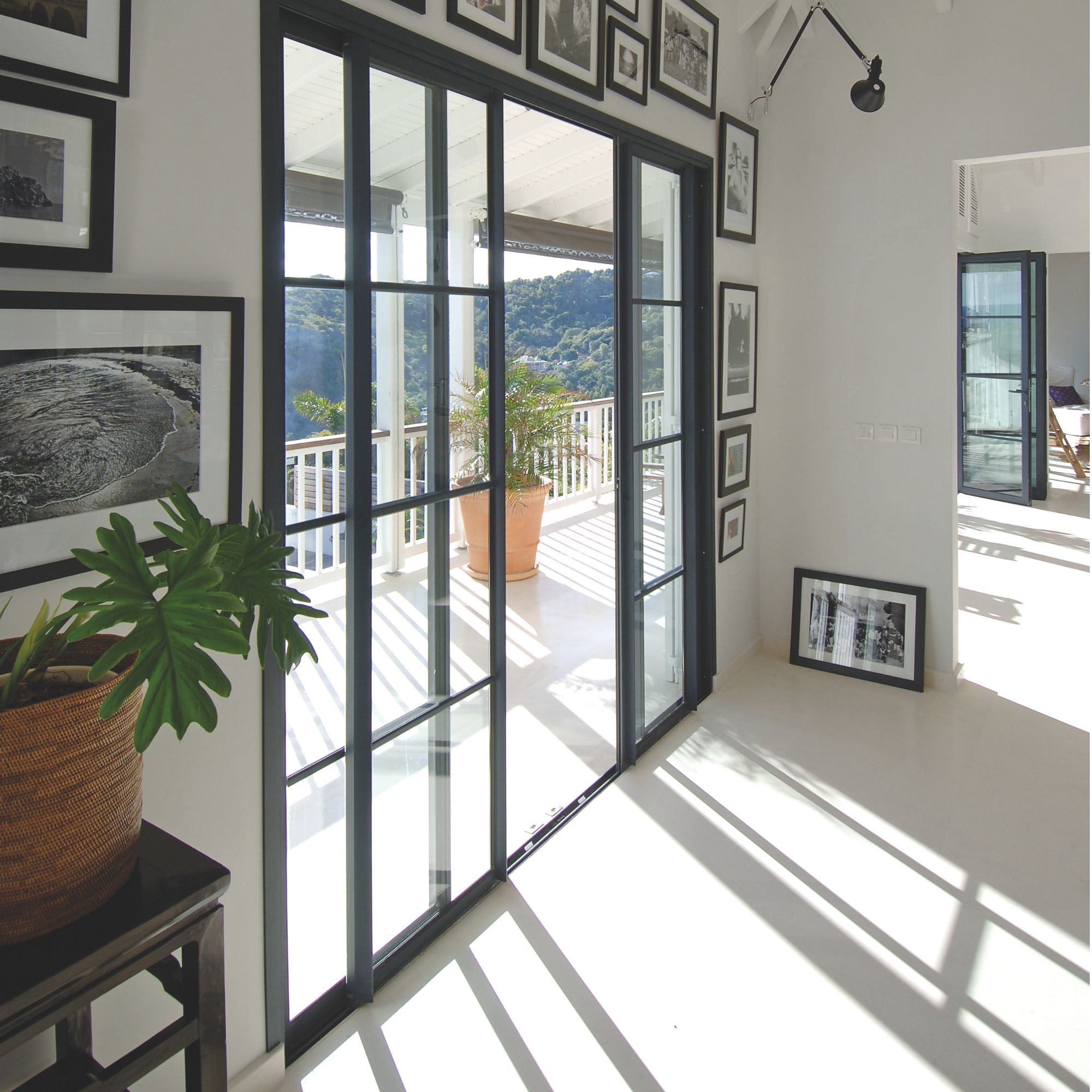 Polished concrete flooring inside and out with steel-look sliding patio doors on to a veranda