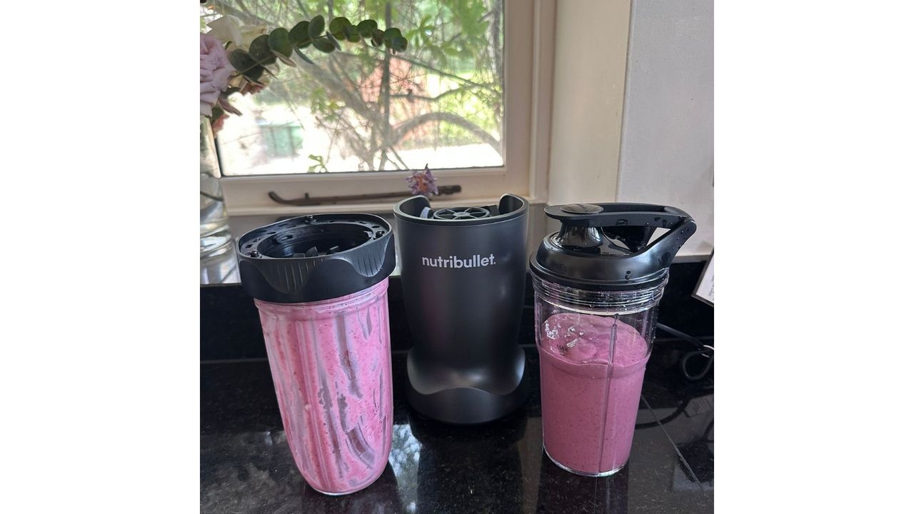 Nutribullet Turbo blender filled with fresh fruit and other ingredients, styled on a kitchen worktop