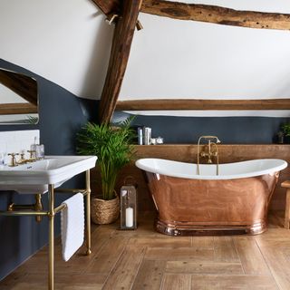wood look porcelain tiles in bathroom with copper bath