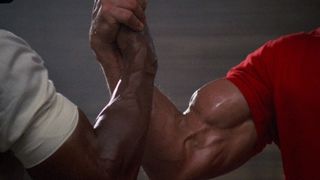 Arnold Schwarzenegger and Carl Weathers in the manliest handshake in movie history in Predator