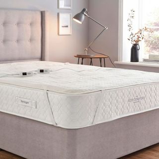 A Silentnight electric blanket with dual controls on the bed in a bedroom