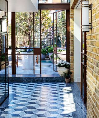 Modern entryway with tiled floor and glass doors