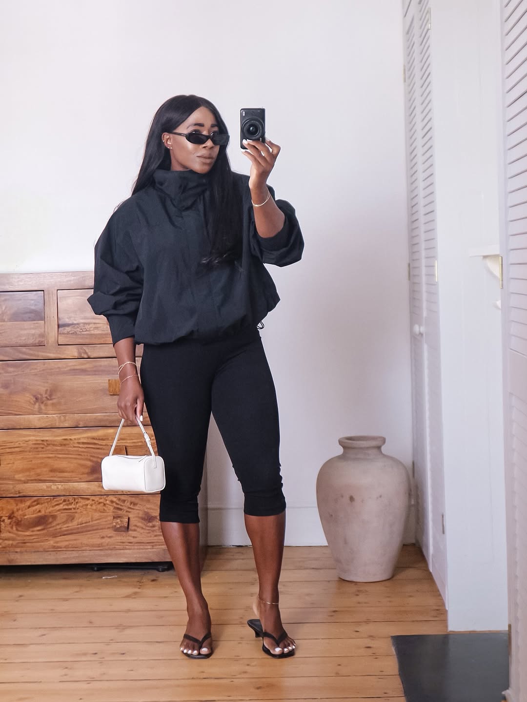 woman wearing black capri pants outfits 2025