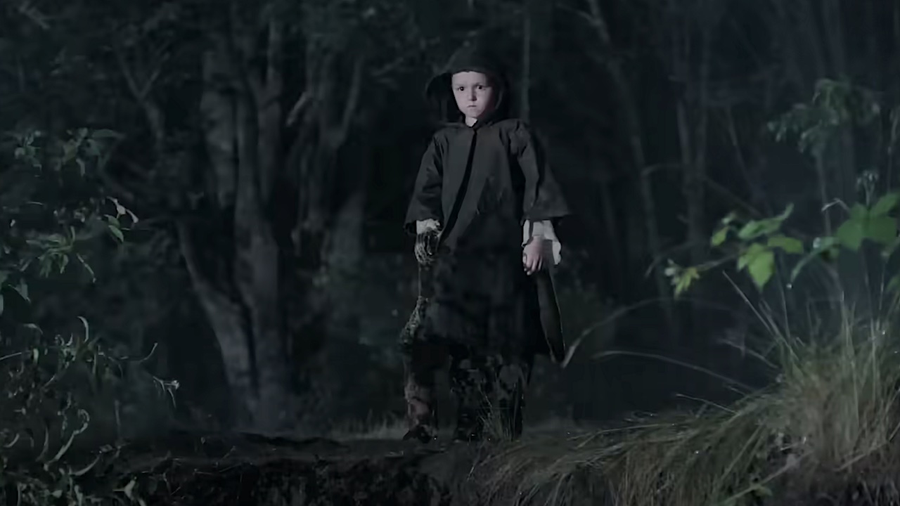 A very young Seraphite child standing in the woods in the dark in The Last of Us Season 2 finale
