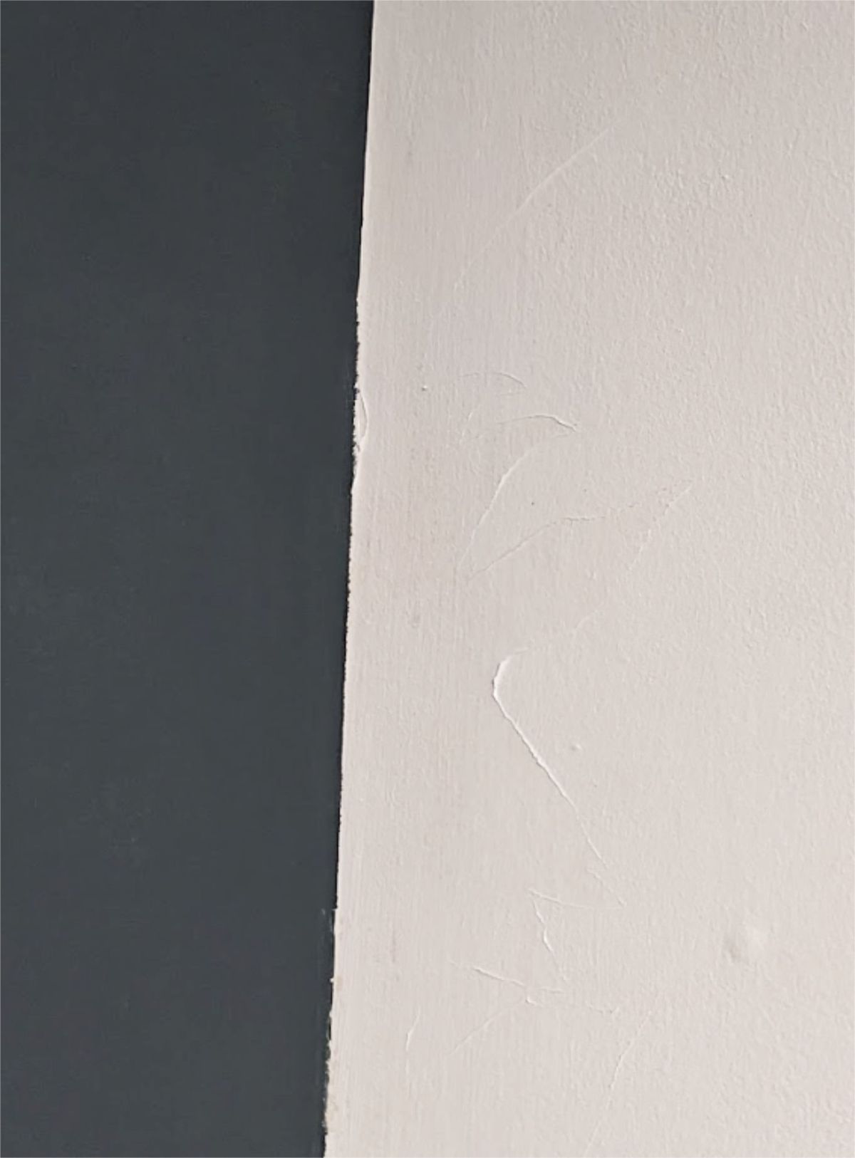 Paint peeling off a white wall