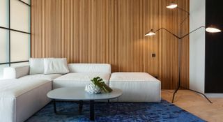 Modern living room setting with a timber panelled wall