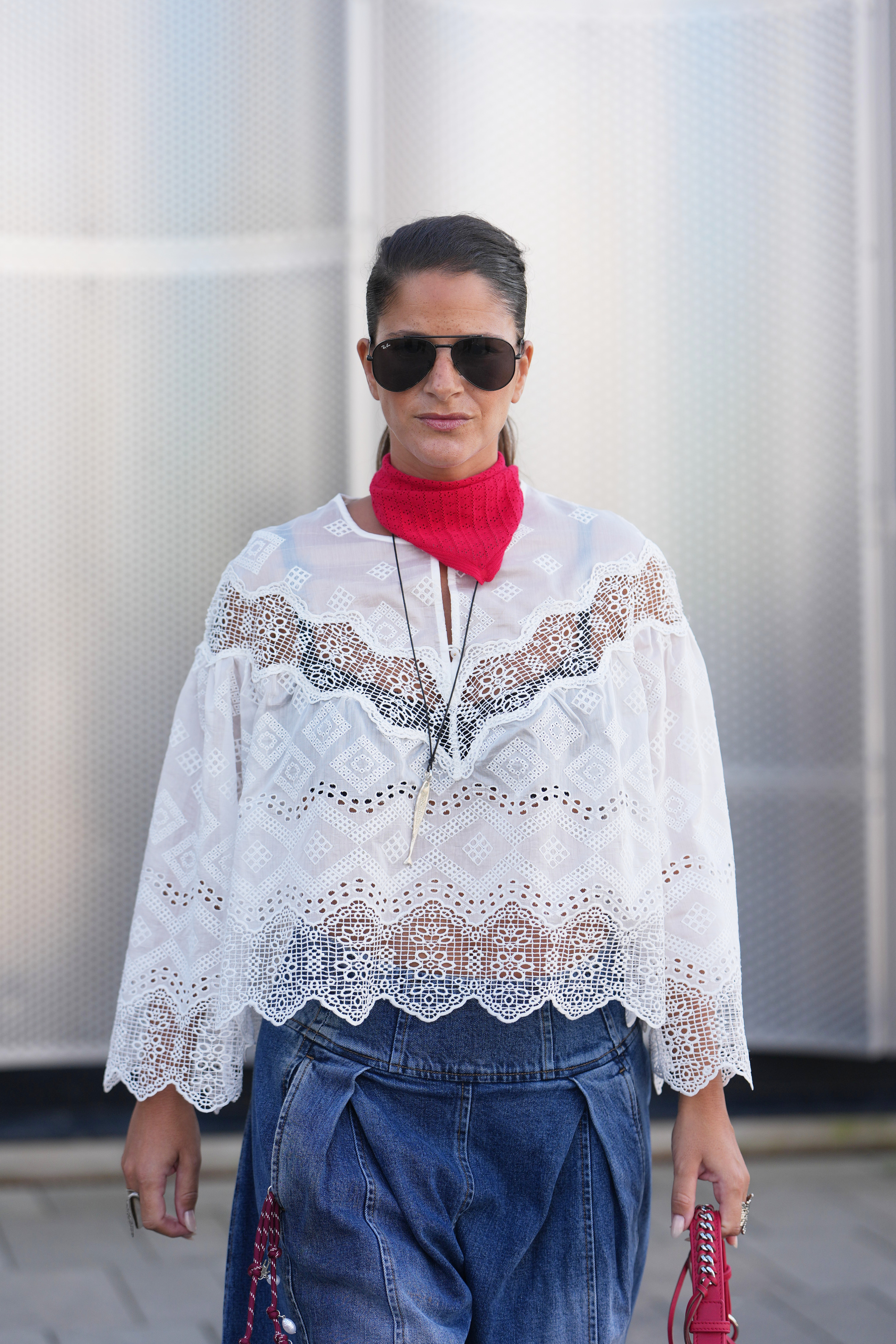 A guest wore the white lace top trend at Copenhagen Fashion Week