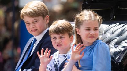 Prince George, Princess Charlotte, and Prince Louis ride in the carriage procession at Trooping the Colour
