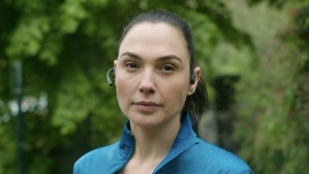 Gal Gadot talking on the phone at the start of The Runner. 