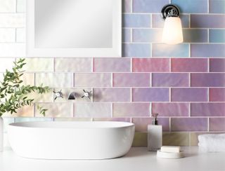 holographic style bathroom tiles in pink and blue hues with white sink