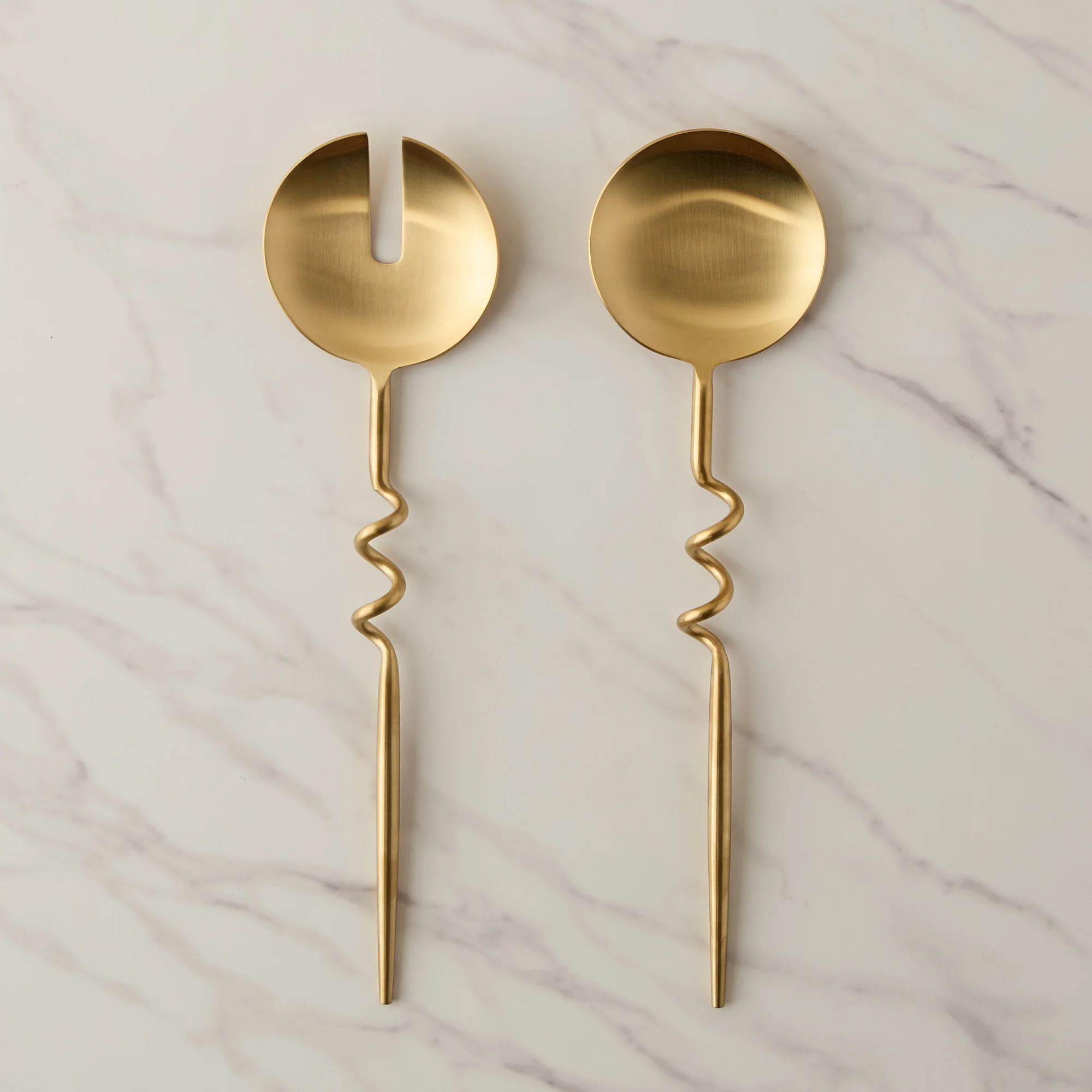 Gold serving spoons with squiggle handle detail