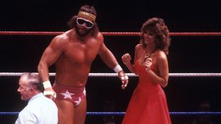 Randy Savage and Miss Elizabeth, standing in a WWF (WWE) ring, looking at the referee