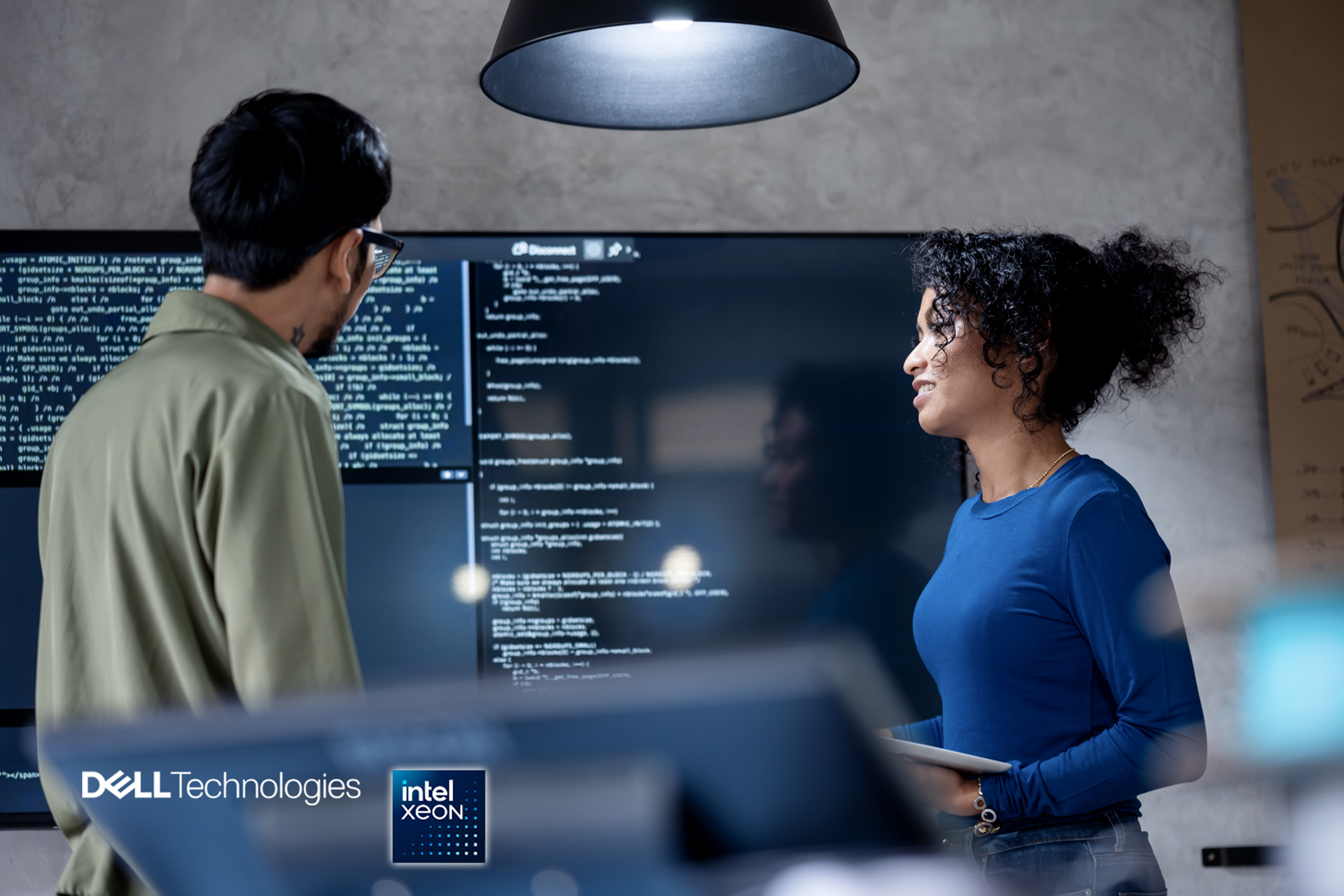 Man and woman in front of computer screen