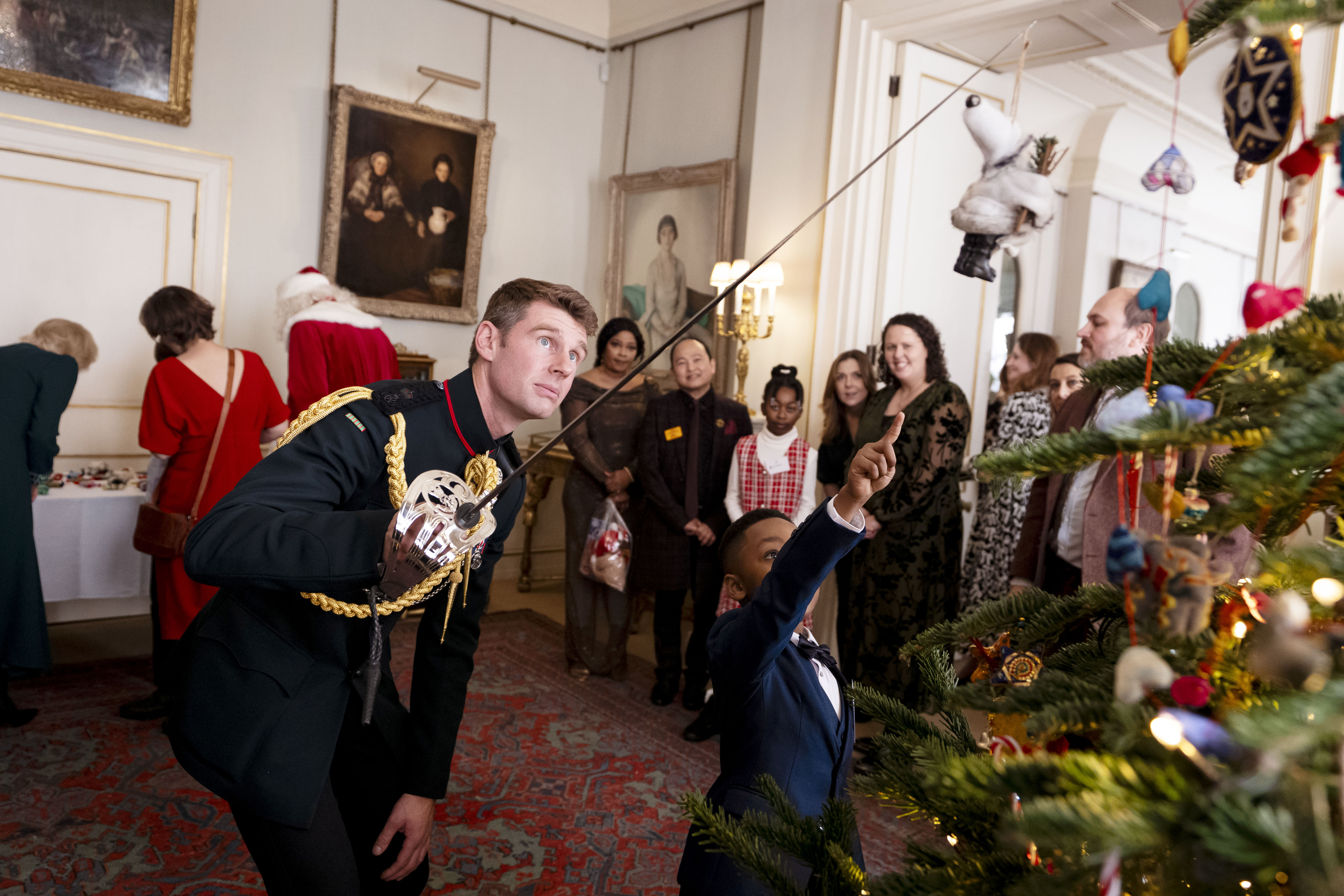 Rob Treasure decorating a christmas tree with a sword