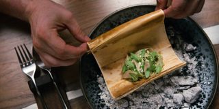 A pair of hands prepare a dish, in 'Chef's Table.'