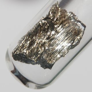 Two grams of ultrapure sublimated samarium, about 0.8 by 1.5 cm.