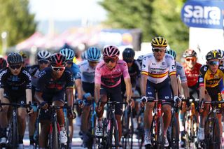 Overall leader Team Ineos rider Colombias Egan Bernal C and the pack cross the finish line of the twelfth stage of the Giro dItalia 2021 cycling race 212 km between Siena and Bagno di Romagna on May 20 2021 Photo by Luca Bettini AFP Photo by LUCA BETTINIAFP via Getty Images