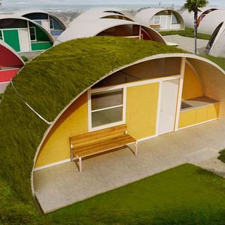 binishell with green lawn wooden bench