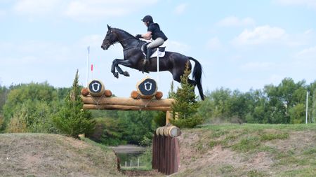 Katie Magee and Treworra jump a cross-country fence on their way to winning the 2025 British Open Championship.