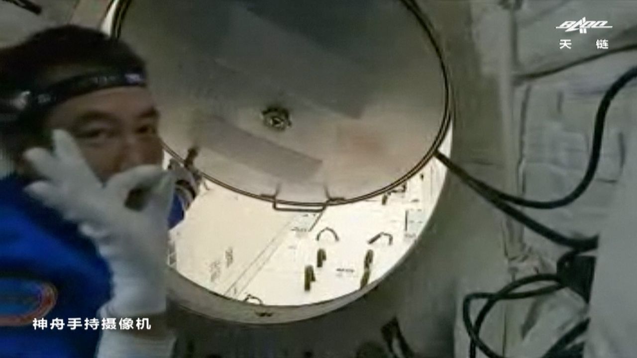 Shenzhou 13 commander Zhai Zhigang opens the hatch between China's Shenzhou 13 spacecraft and the Tianhe core module of the Tiangong space station after a successful docking on Oct. 16, 2021.