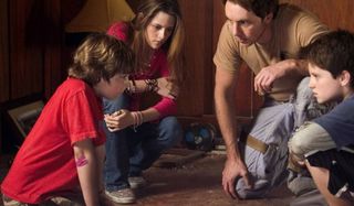 Zathura Kristen Stewart and Josh Hutcherson huddle with Dax Shepard and Jonah Bobo