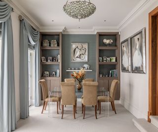 Blue wall and drapes, suede chairs glass table