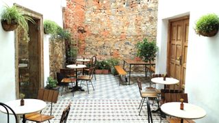 courtyard at cape town bar, white tile floors and brick walls