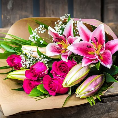 roses lilies wooden table with blur background