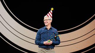 Tim Cook at an Apple event, having loads of fun with a party hat on and popping a party popper