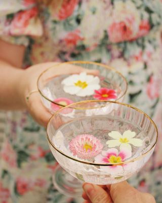Two champagne glasses with edible flowers