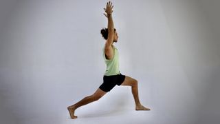 Elisei Rusu demonstrates high lunge yoga position